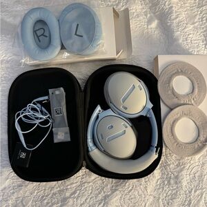 Bose Quiet Comfort Q35, charger, extra pads and covers, extra protectors.